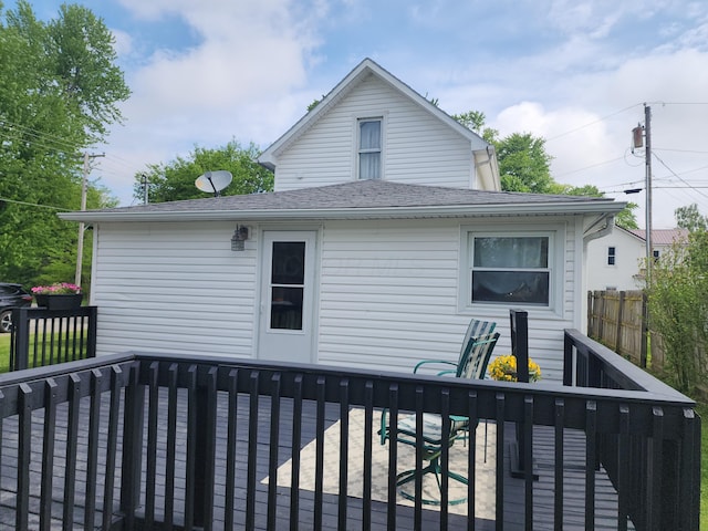 7703 County Road 91, Lewistown, OH 43333 - back of house featuring a wooden deck, fence, and roof with shingles