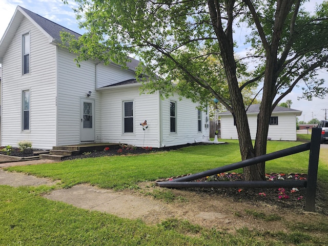 7703 County Road 91, Lewistown, OH 43333 - rear view of house with roof with shingles and a yard