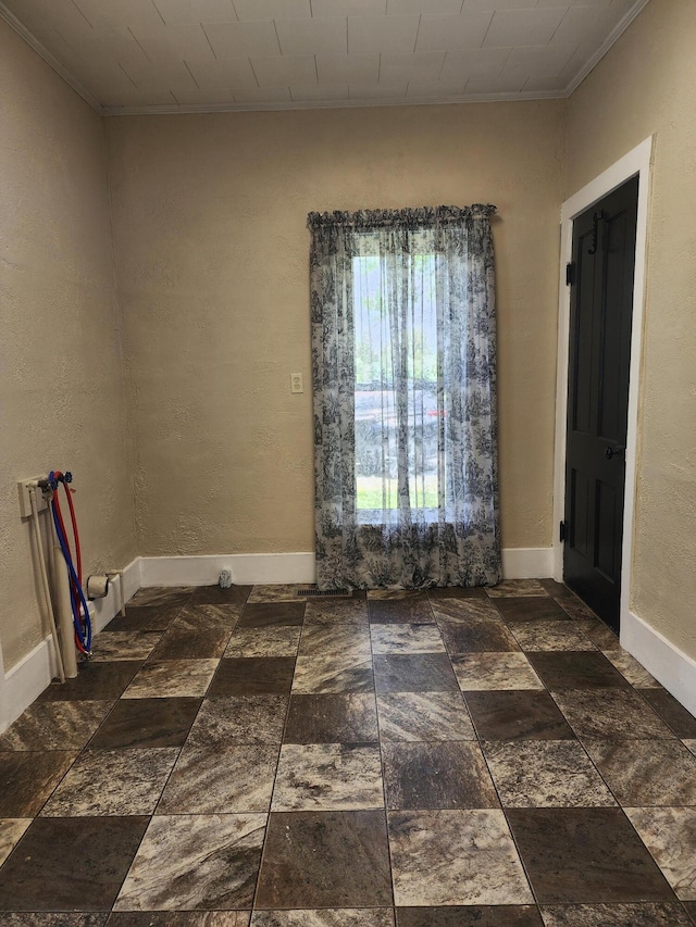 7703 County Road 91, Lewistown, OH 43333 - unfurnished room with ornamental molding, baseboards, and stone finish floors