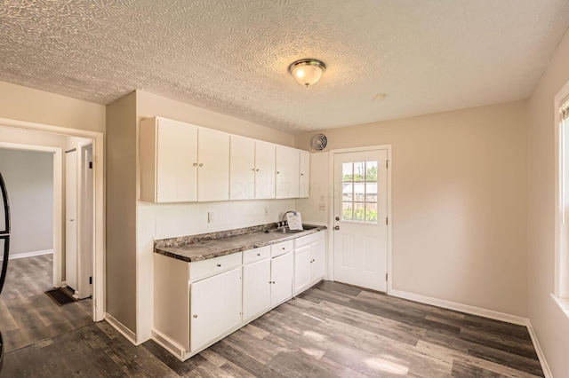 4309 Walford St, Columbus, OH 43224 - kitchen featuring dark wood-style flooring, white cabinets, and a textured ceiling