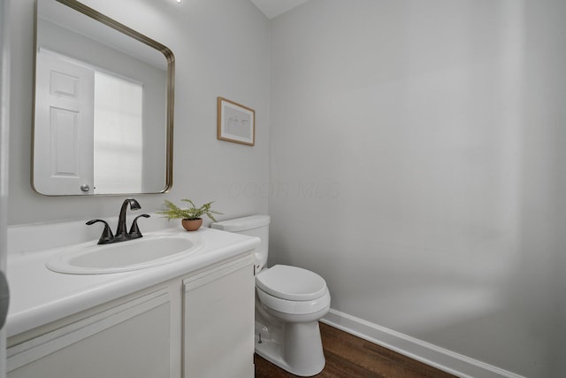5394 Ambrosia Ave Unit 21B, Columbus, OH 43235 - bathroom featuring toilet, vanity, wood finished floors, and baseboards