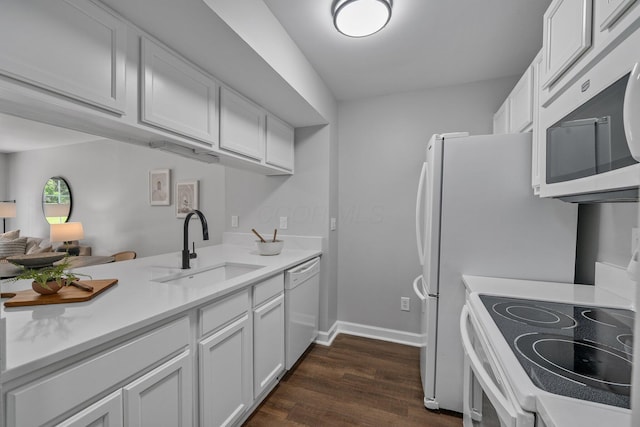 5394 Ambrosia Ave Unit 21B, Columbus, OH 43235 - kitchen featuring white appliances, a sink, dark wood-style flooring, light countertops, and white cabinetry