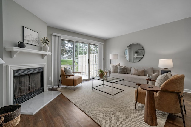 5394 Ambrosia Ave Unit 21B, Columbus, OH 43235 - living room featuring wood finished floors, a fireplace with raised hearth, and baseboards