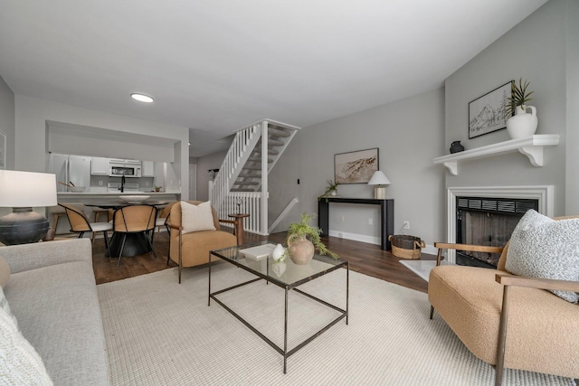 5394 Ambrosia Ave Unit 21B, Columbus, OH 43235 - living room with light wood-style flooring, stairway, a fireplace, recessed lighting, and baseboards
