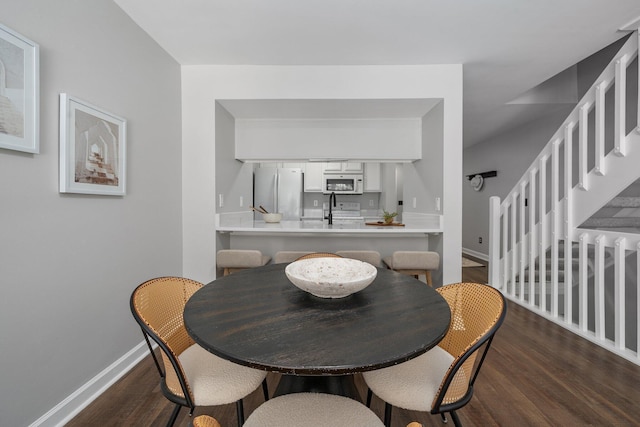 5394 Ambrosia Ave Unit 21B, Columbus, OH 43235 - dining area featuring wood finished floors, baseboards, and stairs