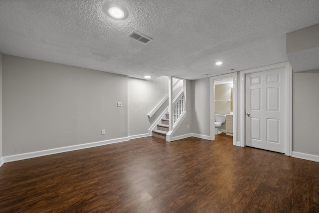 5394 Ambrosia Ave Unit 21B, Columbus, OH 43235 - finished basement with a textured ceiling, wood finished floors, stairway, baseboards, and recessed lighting