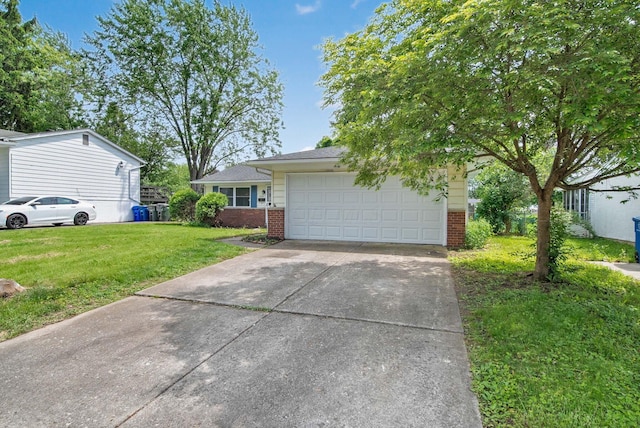 4861 Warminster Dr, Columbus, OH 43232 - view of front of house with brick siding, concrete driveway, a front lawn, and an attached garage
