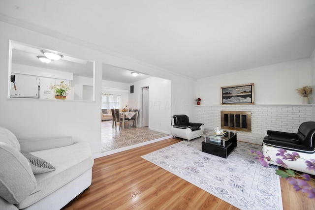 4861 Warminster Dr, Columbus, OH 43232 - living area featuring light wood-type flooring, baseboards, and a fireplace