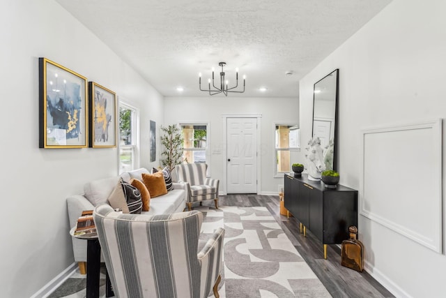 568 Wilson Ave, Marion, OH 43302 - living room with a chandelier, wood finished floors, a textured ceiling, baseboards, and recessed lighting