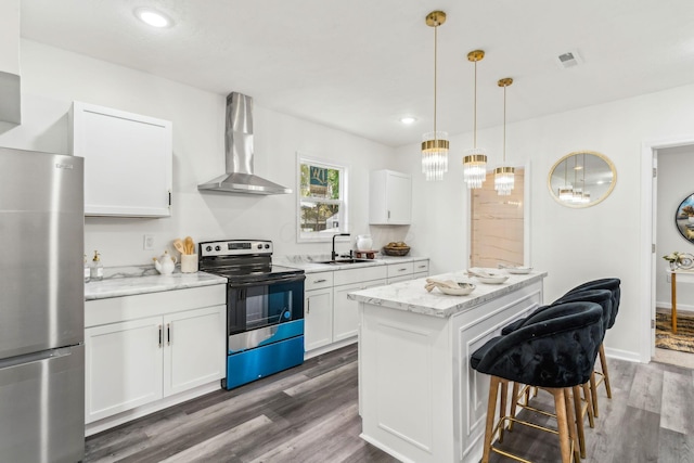 568 Wilson Ave, Marion, OH 43302 - kitchen with electric range, freestanding refrigerator, wall chimney range hood, a sink, and a breakfast bar