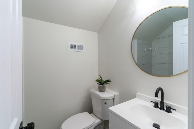 568 Wilson Ave, Marion, OH 43302 - bathroom with lofted ceiling, vanity, and toilet
