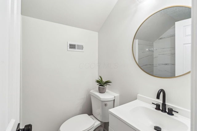 568 Wilson Ave, Marion, OH 43302 - bathroom with vanity, toilet, and vaulted ceiling