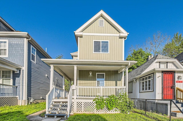 view of front of property with a porch, stairway, and board and batten siding