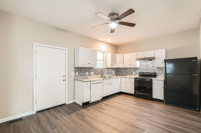 kitchen with black appliances, under cabinet range hood, ceiling fan, dark wood-style flooring, and tasteful backsplash