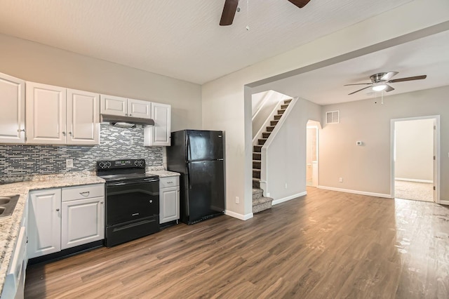 kitchen with black appliances, ceiling fan, under cabinet range hood, backsplash, and wood finished floors
