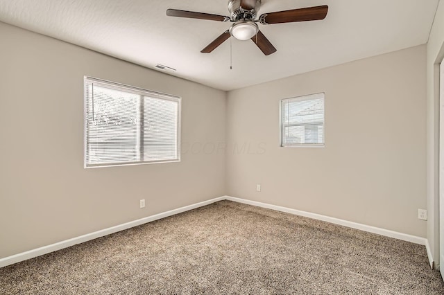 unfurnished room featuring carpet, baseboards, and a ceiling fan