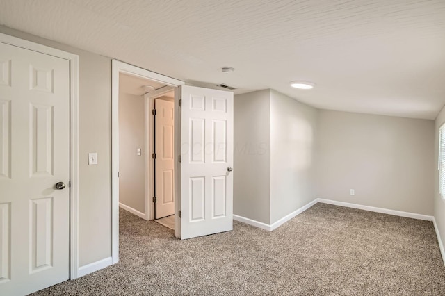 below grade area featuring light carpet and baseboards