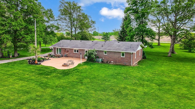13742 State Rte 41, Jeffersonville, OH 43128 - rear view of house with a patio, brick siding, a yard, and cooling unit