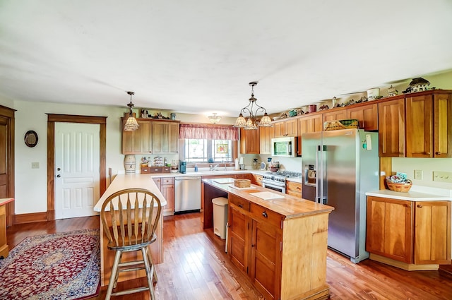 13742 State Rte 41, Jeffersonville, OH 43128 - kitchen featuring stainless steel appliances, a center island, and wood finished floors