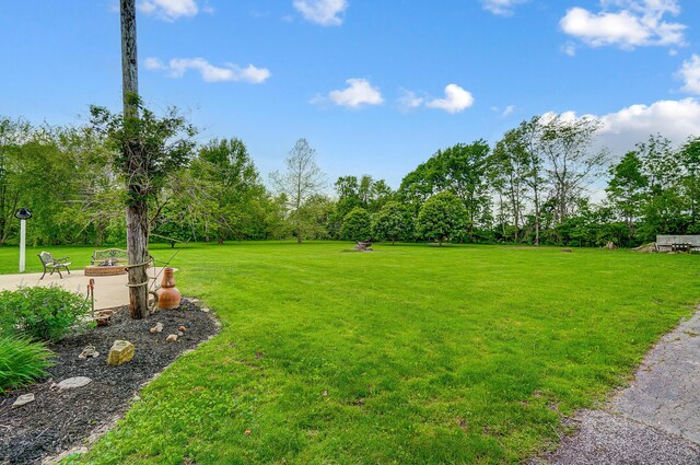 13742 State Rte 41, Jeffersonville, OH 43128 - view of grassy yard with a patio area and view of wooded area