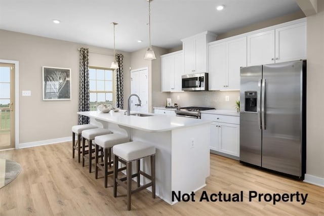 1304 Walsh Dr, Reynoldsburg, OH 43068 - kitchen featuring appliances with stainless steel finishes, a sink, plenty of natural light, a kitchen island with sink, and recessed lighting