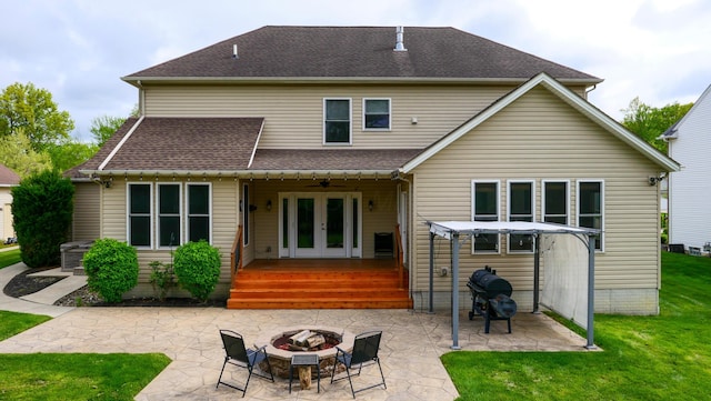 21252 Breckenridge Ln, Strongsville, OH 44149 - back of house featuring french doors, an outdoor fire pit, a lawn, a patio area, and a shingled roof