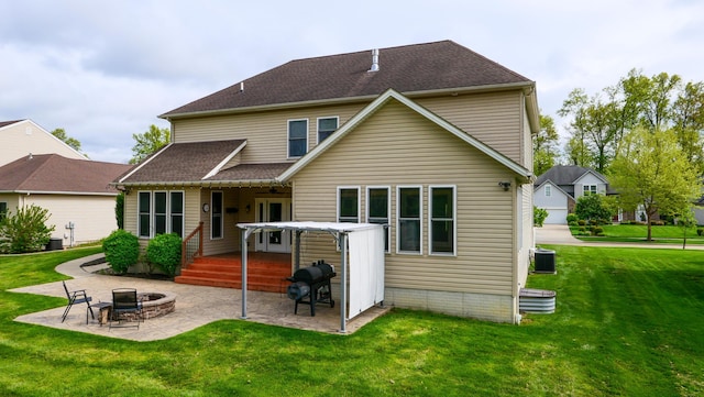 21252 Breckenridge Ln, Strongsville, OH 44149 - back of property featuring a fire pit, a patio area, a lawn, central AC unit, and a deck