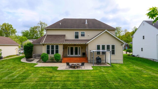 21252 Breckenridge Ln, Strongsville, OH 44149 - back of house with french doors, an outdoor fire pit, a patio area, and a lawn
