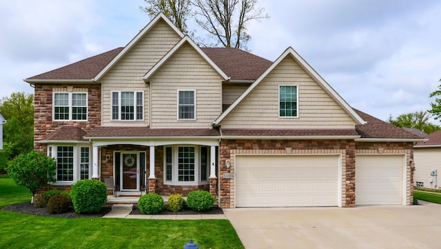 21252 Breckenridge Ln, Strongsville, OH 44149 - craftsman-style home with concrete driveway, a shingled roof, a front yard, and stone siding