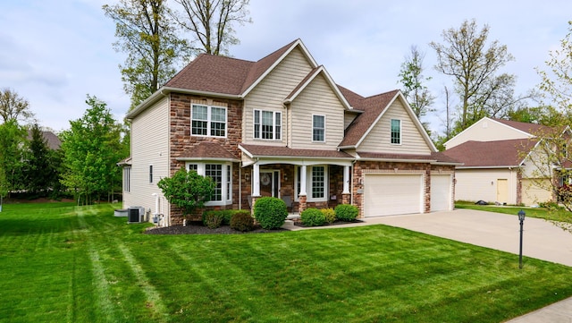 21252 Breckenridge Ln, Strongsville, OH 44149 - view of front of home featuring covered porch, concrete driveway, stone siding, and a front lawn