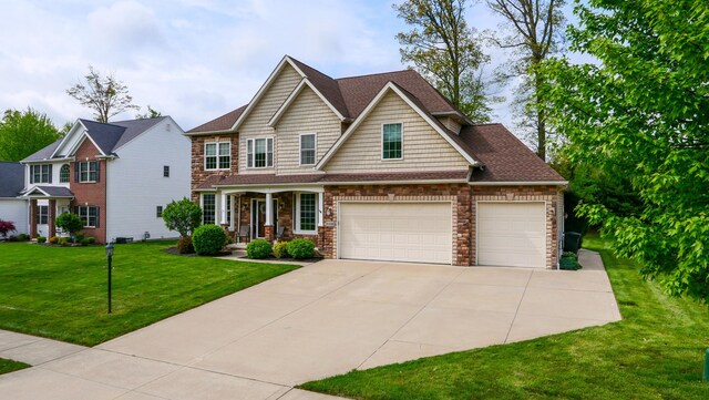 21252 Breckenridge Ln, Strongsville, OH 44149 - view of front facade featuring concrete driveway, a front lawn, covered porch, a garage, and stone siding