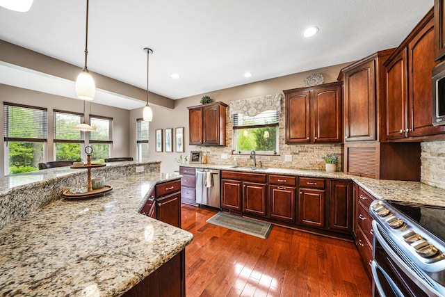 21252 Breckenridge Ln, Strongsville, OH 44149 - kitchen with a sink, appliances with stainless steel finishes, backsplash, light stone countertops, and recessed lighting