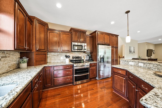 21252 Breckenridge Ln, Strongsville, OH 44149 - kitchen with appliances with stainless steel finishes, pendant lighting, dark wood-style flooring, light stone countertops, and recessed lighting