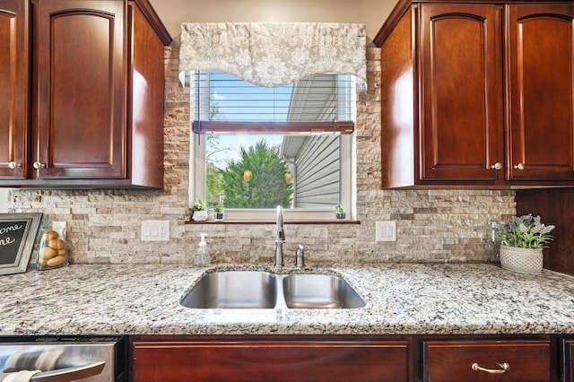 21252 Breckenridge Ln, Strongsville, OH 44149 - kitchen featuring a sink, decorative backsplash, light stone counters, stainless steel dishwasher, and reddish brown cabinets