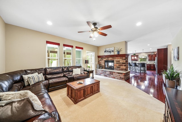 21252 Breckenridge Ln, Strongsville, OH 44149 - living room featuring a ceiling fan, recessed lighting, dark wood-style flooring, a fireplace, and dark colored carpet
