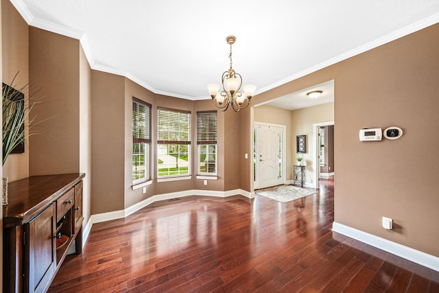 21252 Breckenridge Ln, Strongsville, OH 44149 - unfurnished dining area featuring a chandelier, wood finished floors, baseboards, and crown molding