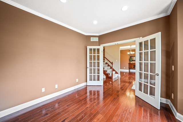 21252 Breckenridge Ln, Strongsville, OH 44149 - unfurnished room featuring french doors, a chandelier, hardwood / wood-style flooring, baseboards, and ornamental molding