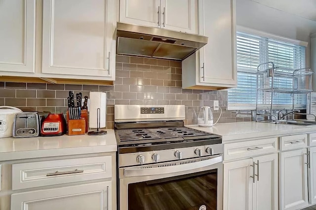 12281 Rooster Tail Dr, Pickerington, OH 43147 - kitchen with gas stove, under cabinet range hood, a sink, light countertops, and white cabinets