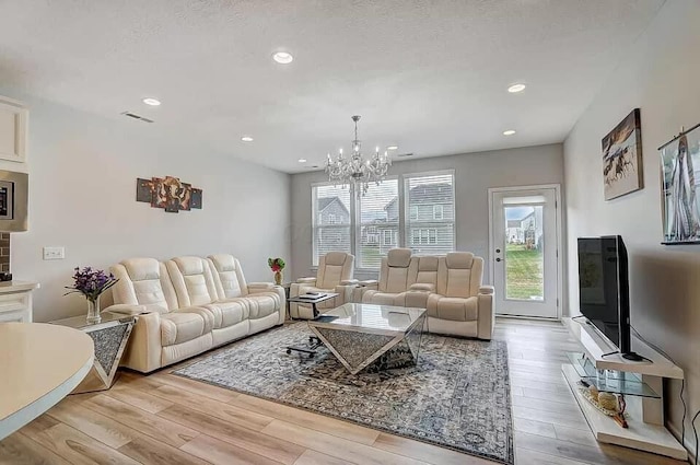12281 Rooster Tail Dr, Pickerington, OH 43147 - living area with light wood finished floors, a chandelier, and recessed lighting