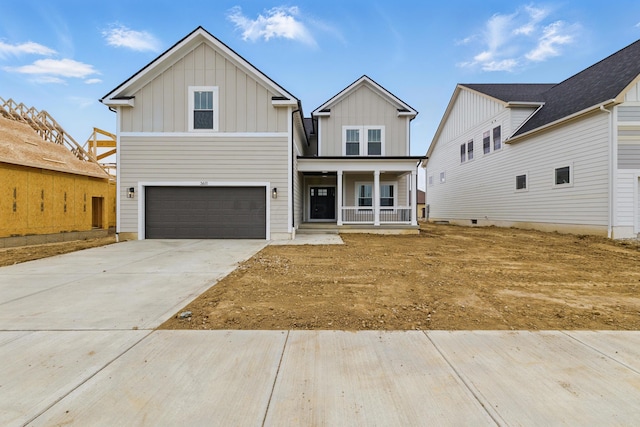 view of front of property featuring board and batten siding, a garage, a porch, and driveway