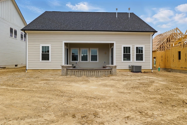 back of property with cooling unit and a shingled roof