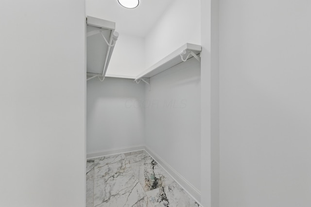 spacious closet with marble look tiles
