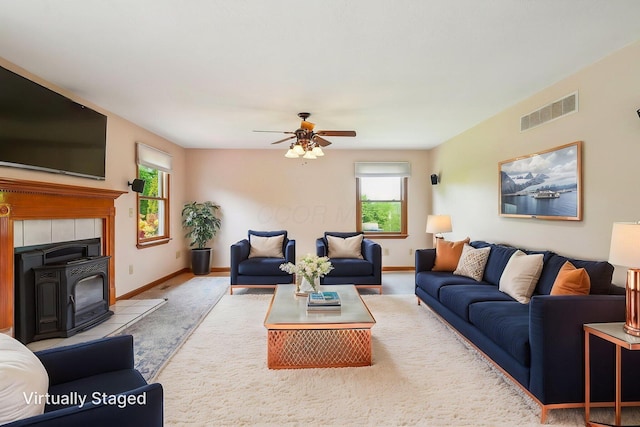 4217 Caswell Rd, Johnstown, OH 43031 - carpeted living room featuring a ceiling fan, baseboards, and a wood stove