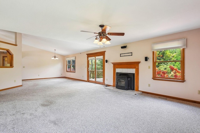 4217 Caswell Rd, Johnstown, OH 43031 - unfurnished living room with a wood stove, carpet, plenty of natural light, baseboards, and vaulted ceiling