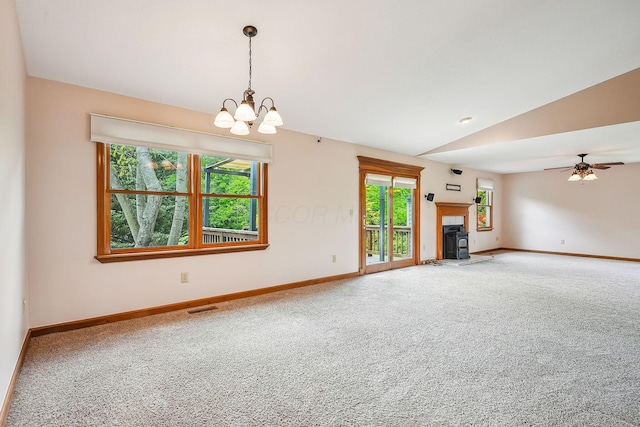 4217 Caswell Rd, Johnstown, OH 43031 - unfurnished living room with carpet floors, baseboards, vaulted ceiling, and a wood stove