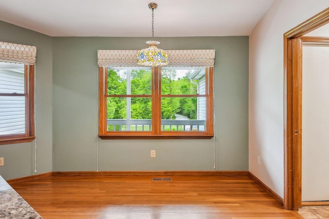 4217 Caswell Rd, Johnstown, OH 43031 - unfurnished dining area featuring light wood-style flooring, a chandelier, and baseboards