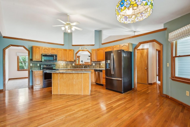 4217 Caswell Rd, Johnstown, OH 43031 - kitchen with stainless steel appliances, arched walkways, a sink, tasteful backsplash, and baseboards