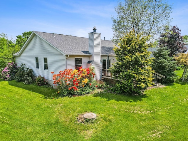 4217 Caswell Rd, Johnstown, OH 43031 - back of house with a chimney, roof with shingles, a yard, and a deck