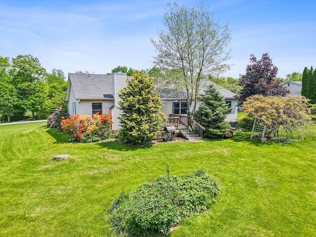 4217 Caswell Rd, Johnstown, OH 43031 - rear view of property with a chimney, a yard, and a wooden deck