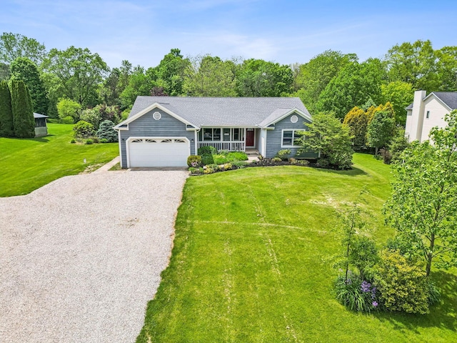 4217 Caswell Rd, Johnstown, OH 43031 - view of front of home featuring a garage, gravel driveway, a front yard, and a porch